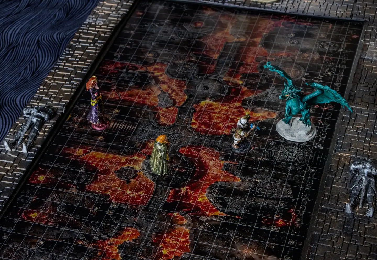 Close up of a lava map on the Doungim board, with a dragon and other miniatures on it
